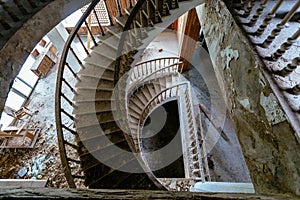 Top view of old vintage decorated spiral staircase in abandoned mansion