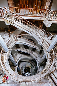 Top view of old vintage decorated spiral staircase in abandoned mansion