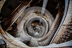 Top view of old vintage decorated spiral staircase in abandoned mansion