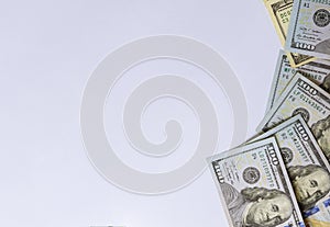 Top view of one hundred dollar bills on white background