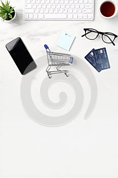 Top view of online shopping concept with credit card, smart phone and computer