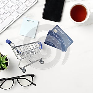 Top view of online shopping concept with credit card, smart phone and computer