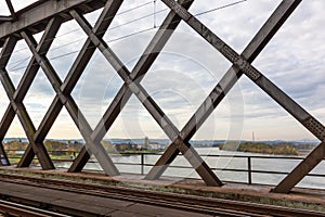 Top view onto the river Rhine through the steel girders of a crossing railway bridge