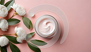 Top view open cosmetic cream jar container, white flowers and green leaves on pink background