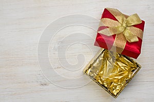 Top view of open gift box on wooden texture background