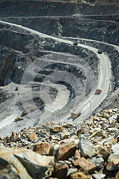 Top view, open pit work. Large quarry dump trucks