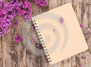 Top view of open school notebook with blank pages, on wooden old table