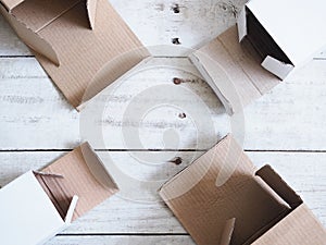 Top view of opened deliverly brown corrugated cardboard box on wooden background