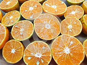 Top view of orange fruit slice on cutting board as a background ready to eat or making drinks