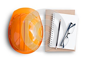 Top view with orange safety engineer helmet and blank notebook