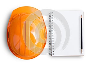 Top view with orange safety engineer helmet and blank notebook o