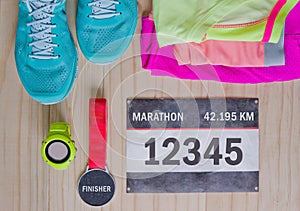 Top view of outfit for runner on wooden background