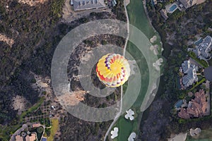 Top view over colorful hot air balloons on the sky over San Diego.