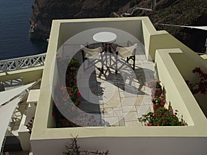 Top view over a table and two chairs, looking out to the sea in Santorini, Greece