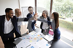 Overjoyed diverse coworkers participate in teambuilding activity photo