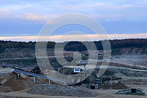 Top view panorama of deep kaolin strip mine with dumper trucks and cranes. Quarry for the extraction of minerals.