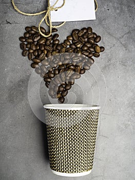 top view paper coffee to go cup and heart made from coffee beans, mock up paper cup, copy space