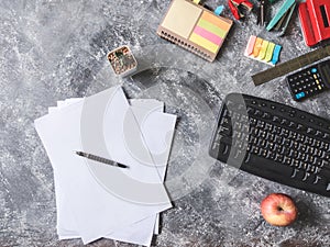 Top view of Paper sheet with Office supplies on Grunge gray background.