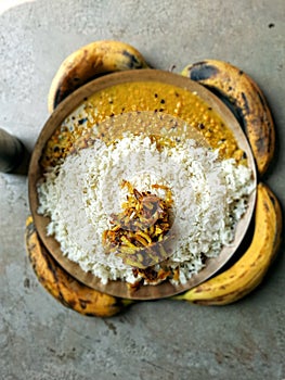 Top view of a pashtun pilaf on a brown plate with ripe bananas photo