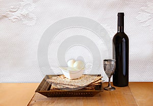 Top view of passover background. matzoh (jewish passover bread) and traditional sedder plate over wooden background