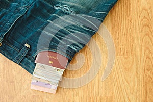 Top view. passport book and money insert on pocket jean pants wi