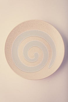 Top view of a pastel plate on a pastel peach background. Minimalism food photography. Geometric style.