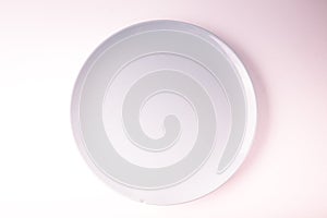 Top view of a pastel plate on a pastel peach background. Minimalism food photography. Geometric style.