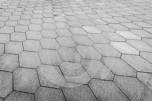 Top view on paving stone road. Old pavement of granite texture