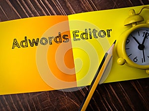 Top view pencil,clock and colored notepaper with text Adwords Editor photo