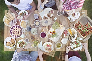 Top view on people eating food during grill party in the garden