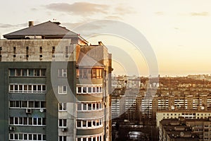 Top view of the people relax on the roof of a multistory building. The roof of a multi-storey building. Sunny sunset. View of the