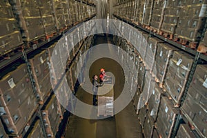 Top view of people standing in megastore with lots of containers on the shelves