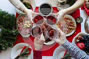 Top view of people toasting with glasses of red wine