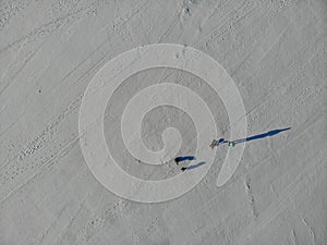 Top view of people walking on a frozen winter river