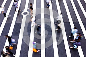 Top view of people walking on pedestrian crosswalk, zebra crossing in street motion in Taipei,Taiwan