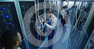 Top view, people work in the data center in the server room