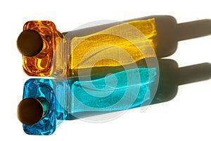 Top view of perfume bottles with hard shadows resembling Ukraine flag on isolated white background