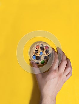 Top view of a person holding the chocolate chip cookie