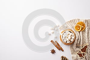 Top view photo of cup of hot cocoa with marshmallow on rattan placemat knitted plaid fir wooden ornament dried orange slices pine