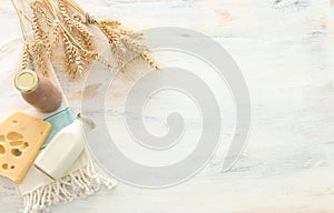 Top view photo of dairy products over white wooden background. Symbols of jewish holiday - Shavuot photo