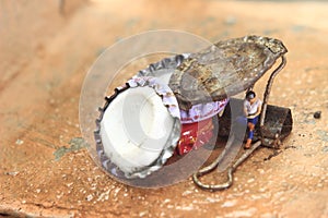 Top View Photo, Gadget Freak or addicted, Sitting Man Holding Smartphone at Corrosive Screw under stack of bottle cups