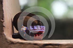 Top View Photo, Gadget Freak or addicted, Sitting Man Holding Smartphone at Corrosive Screw under stack of bottle cups