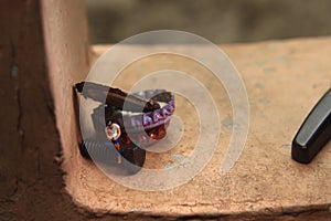 Top View Photo, Gadget Freak or addicted, Sitting Man Holding Smartphone at Corrosive Screw under stack of bottle cups