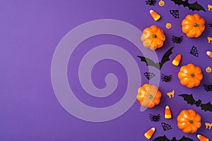 Top view photo of halloween decorations small pumpkins candy corn spiders web cats and bats silhouettes on isolated violet