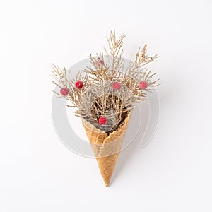 Top view photo of ice cream cone with christmas decorations pine branches and holly berries on isolated white background
