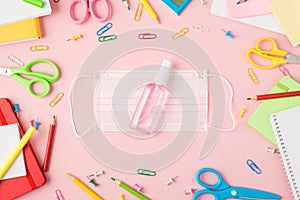 Top view photo of multicolor stationery scissors pens pencils pushpins clips calculator copybooks and sanitizer bottle on medical
