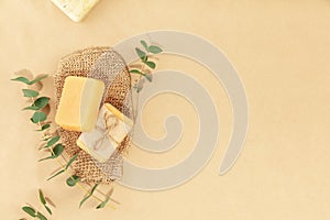 Top view photo of natural hand made soap bar and washcloth on natural beige background