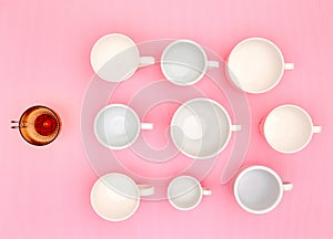 Top view photo of plenty variety of clean white elegant porcelain coffee or tea cups und one red glass cup.