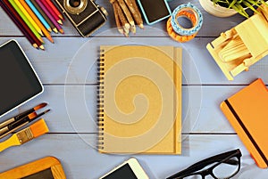 Top view photo of school supplies on wooden table