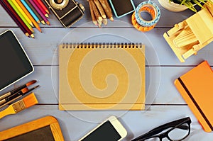 Top view photo of school supplies on wooden table